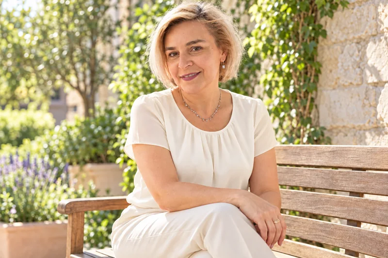 Mariana Țăranu seated on a garden bench
